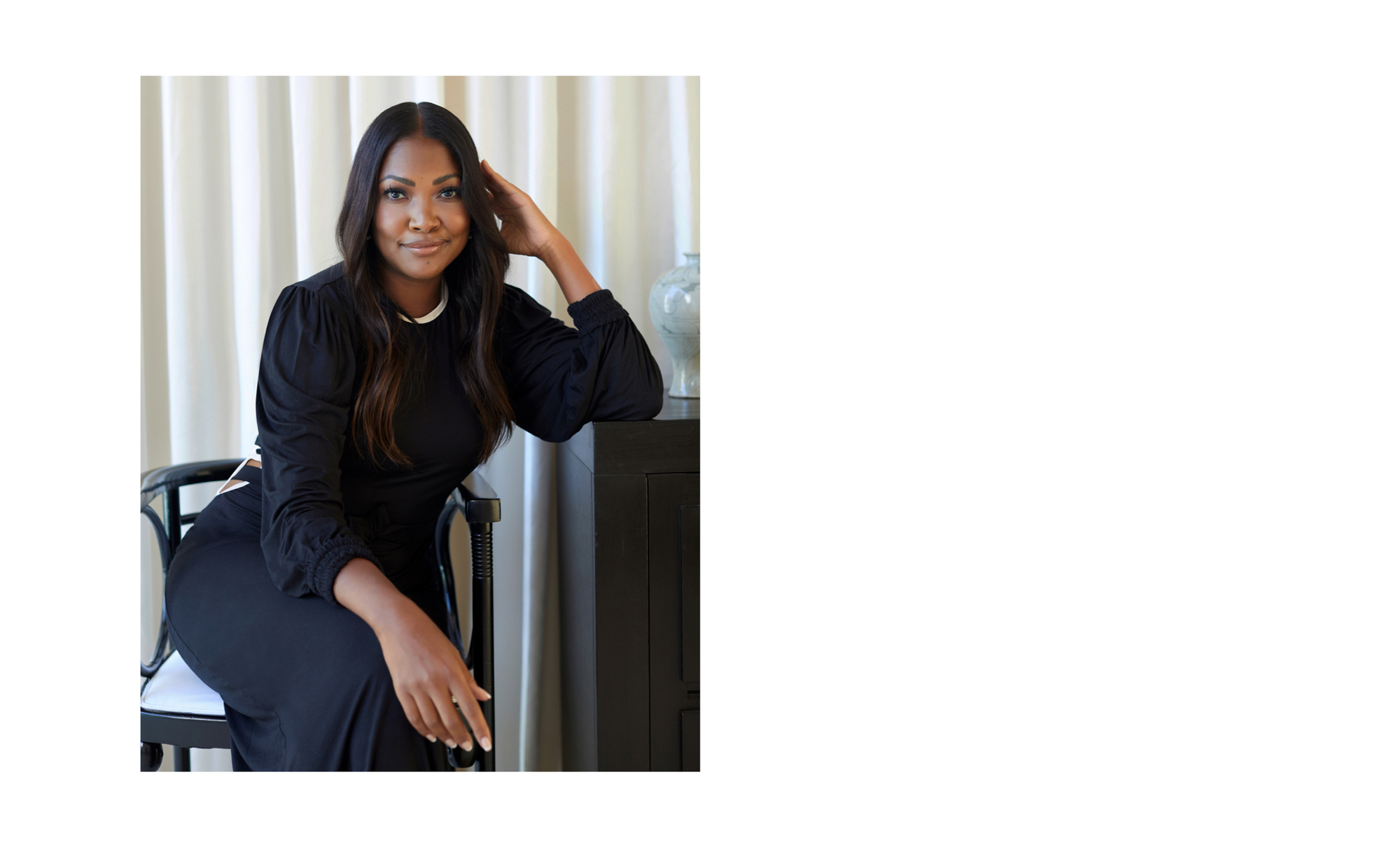 Tracy Robbins sitting in her home in a Johanna Ortiz dress